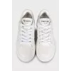 White leather sneakers with a signature logo