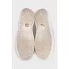 White leather sneakers with a signature logo