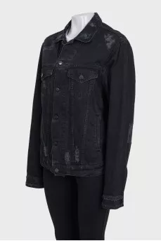 Black denim jacket with a distressed effect