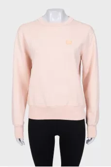 Pink sweatshirt with logo patch