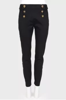 Pants with textured buttons and tag