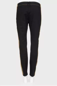 Pants with textured buttons and tag