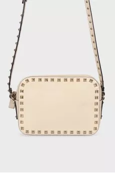 Milk-colored bag with spikes