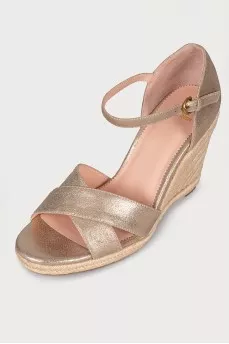 Golden sandals on a jute wedge