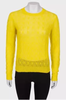 Translucent yellow sweater with a tag