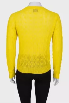 Translucent yellow sweater with a tag