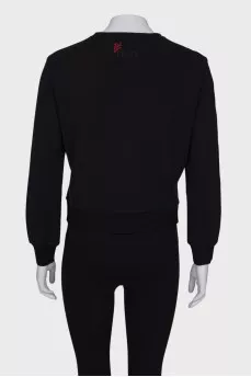 Black sweatshirt with patches on the sleeve