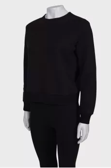 Black sweatshirt with patches on the sleeve