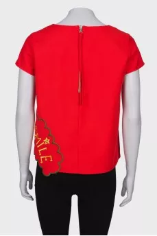 Red blouse with a patch at the bottom
