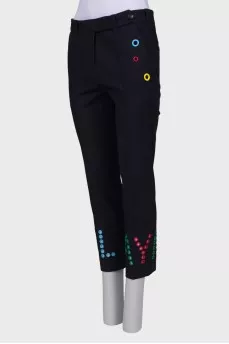 Blue trousers with colored eyelets