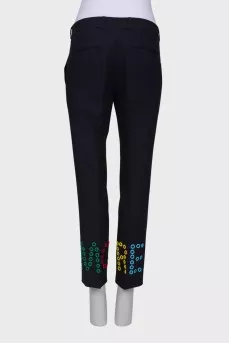 Blue trousers with colored eyelets