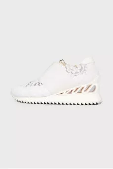 White sneakers with lace inserts