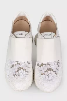 White sneakers with lace inserts