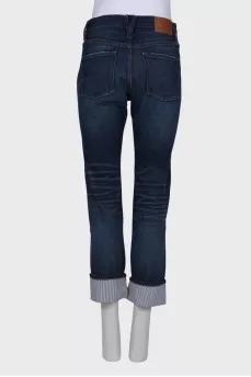 Ripped effect jeans with tag