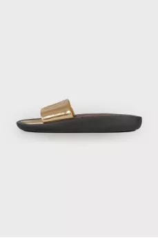 Golden slippers with brand logo