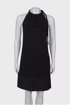 Black dress with ties and pearls