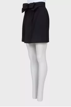 Skirt is decorated with a bow