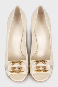White shoes with golden logo