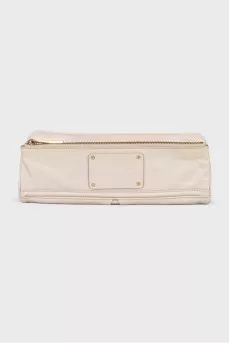 Milk-colored clutch with a zipper