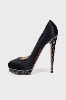 Textile shoes are decorated with rhinestones