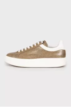 Golden sneakers decorated with rhinestones