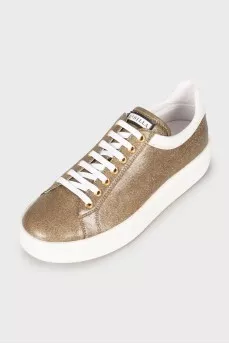 Golden sneakers decorated with rhinestones