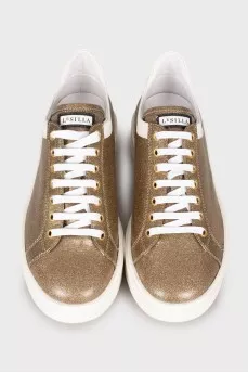 Golden sneakers decorated with rhinestones