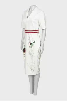 White dress with a pattern on the hem