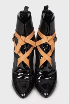 Black leather ankle boots decorated with ties