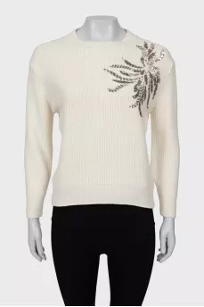 Knitted sweater decorated with sequins