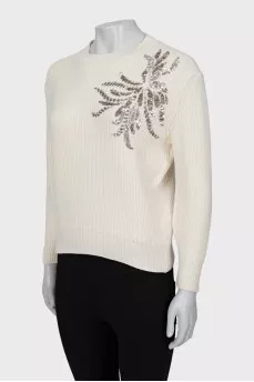 Knitted sweater decorated with sequins
