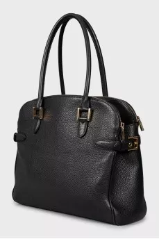 Leather bag decorated with buckles