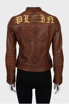 Leather jacket with metal logo on the back
