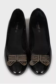 Black leather ballet shoes decorated with a bow