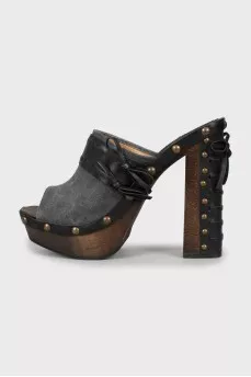 Clogs with leather inserts and metal rivets