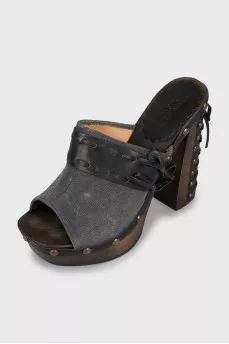 Clogs with leather inserts and metal rivets