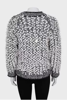 Knitted sweater decorated with buttons