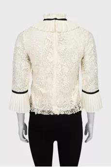 Blouse decorated with frills and ribbon