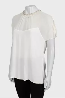 White blouse decorated with rhinestones