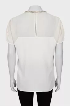 White blouse decorated with rhinestones