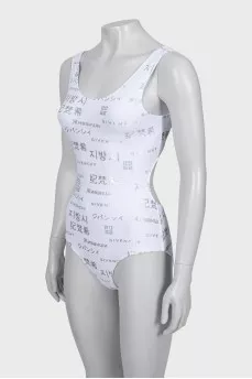 One-piece swimsuit with text print and tag