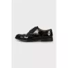 Black patent leather brogues
