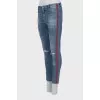 Jeans with stripes and ripped effect