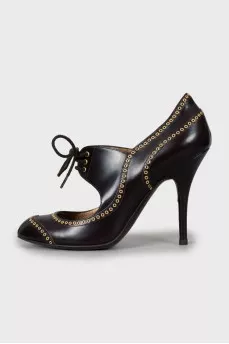 Leather shoes decorated with eyelets