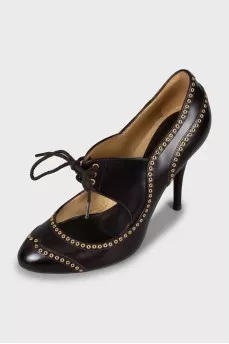 Leather shoes decorated with eyelets
