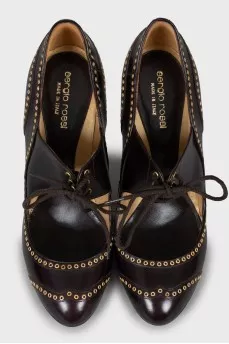 Leather shoes decorated with eyelets