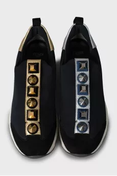 Textile sneakers decorated with spikes