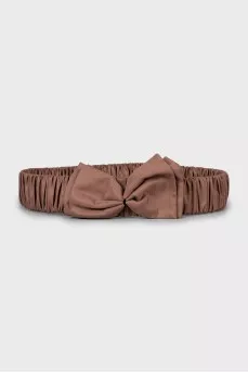 Textile belt with a bow