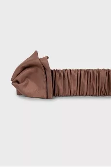 Textile belt with a bow
