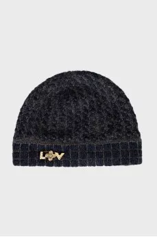 Knitted hat with a golden brooch
